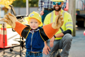 Little boy wearing lineworker gear