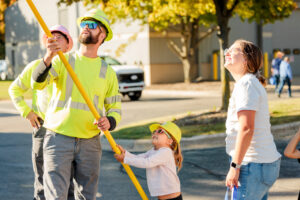 Little girl and lineworker turn on a light